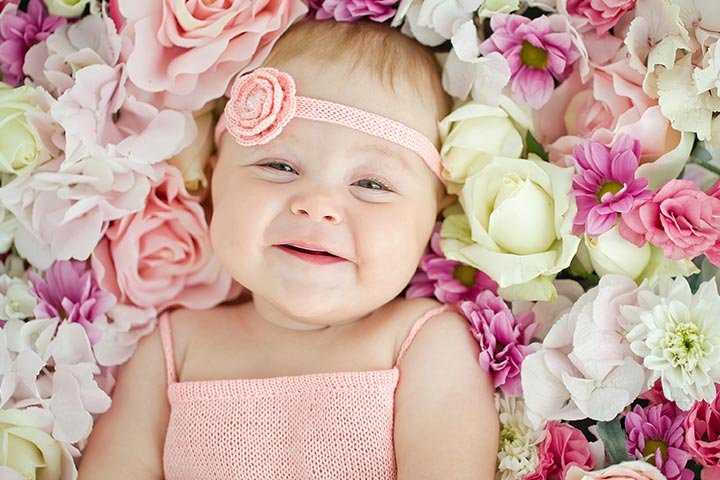 Smiling baby picture of little girl with flowers