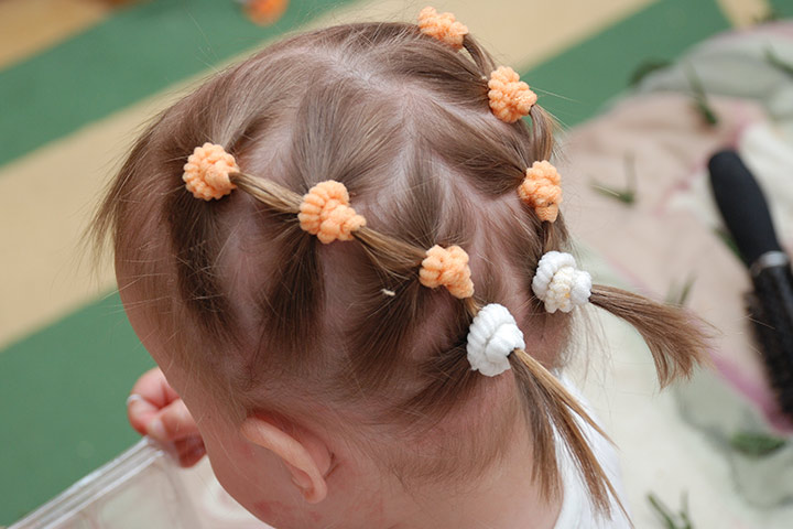 Multiple ponytails with decorative hairbands, toddler girl haircut