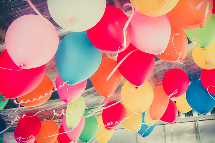 Party with colorful balloons for pregnancy announcement ideas